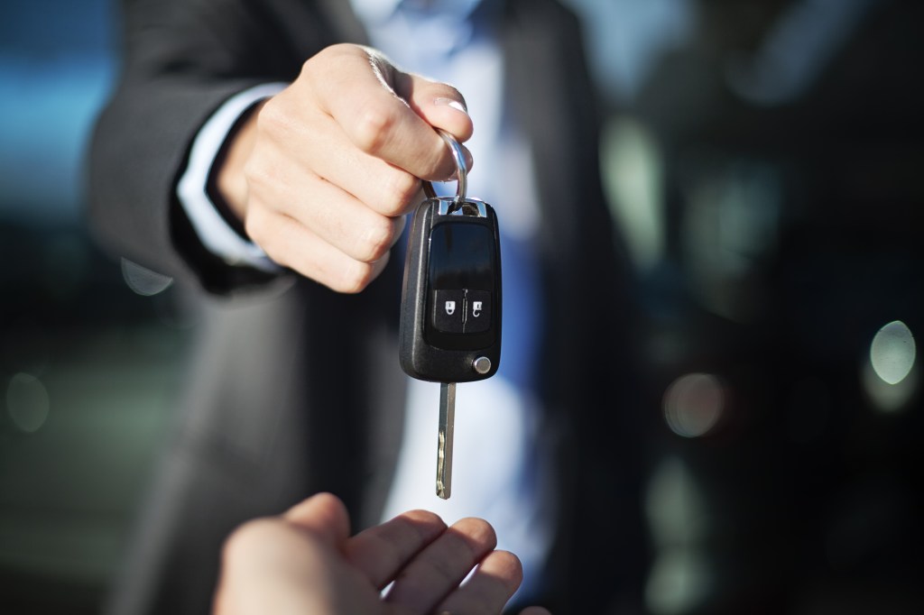 Person receiving new car keys