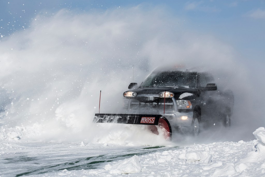 Ram truck plowing through snow