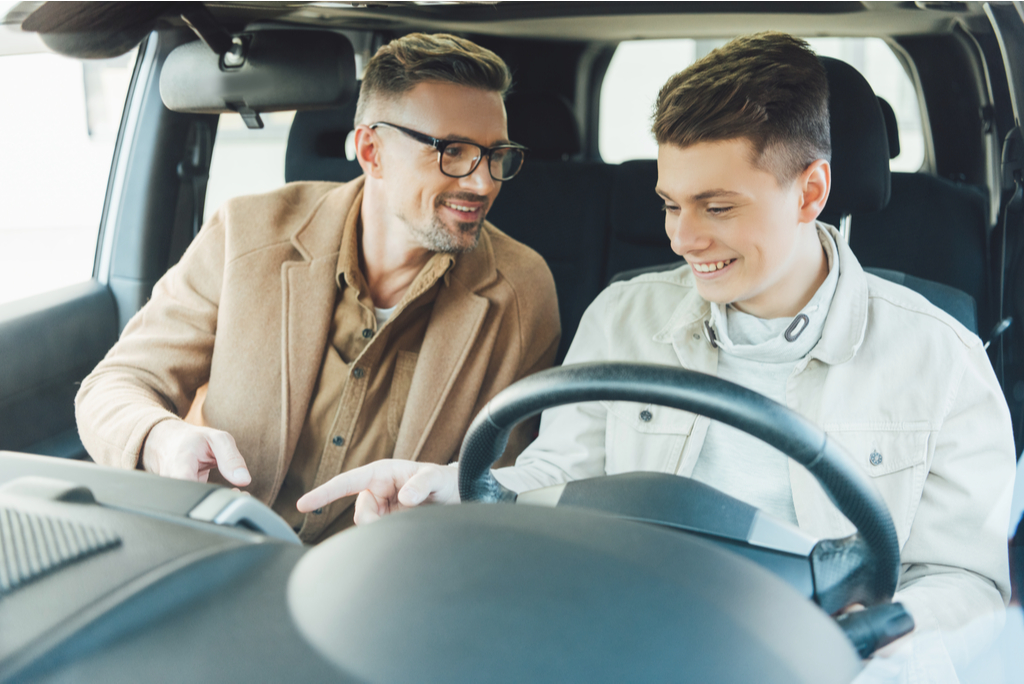 Father and son in dealership car