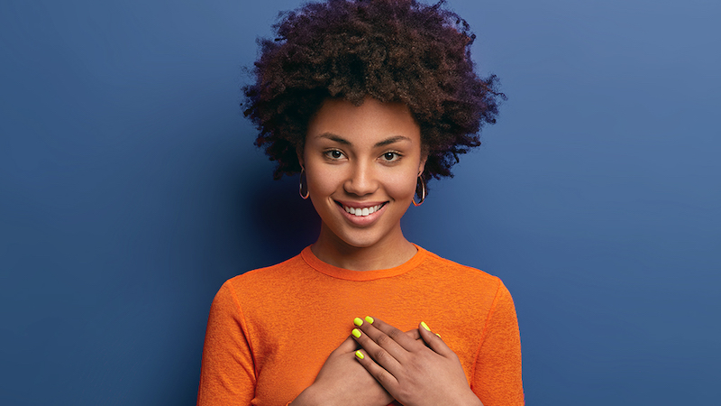 woman with hands folded over chest