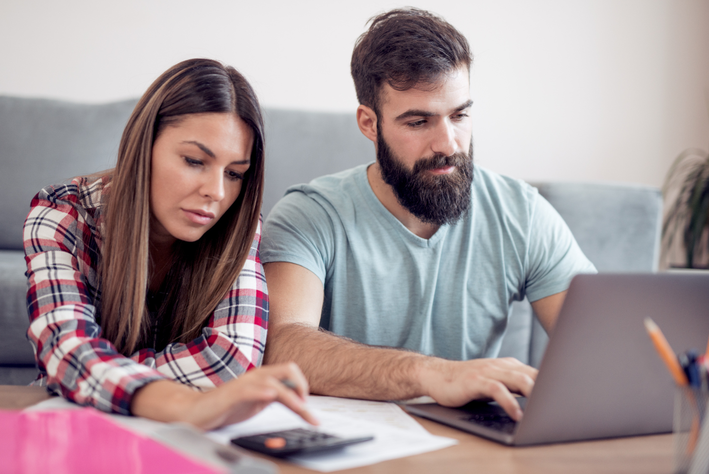 Couple checking finances on computer