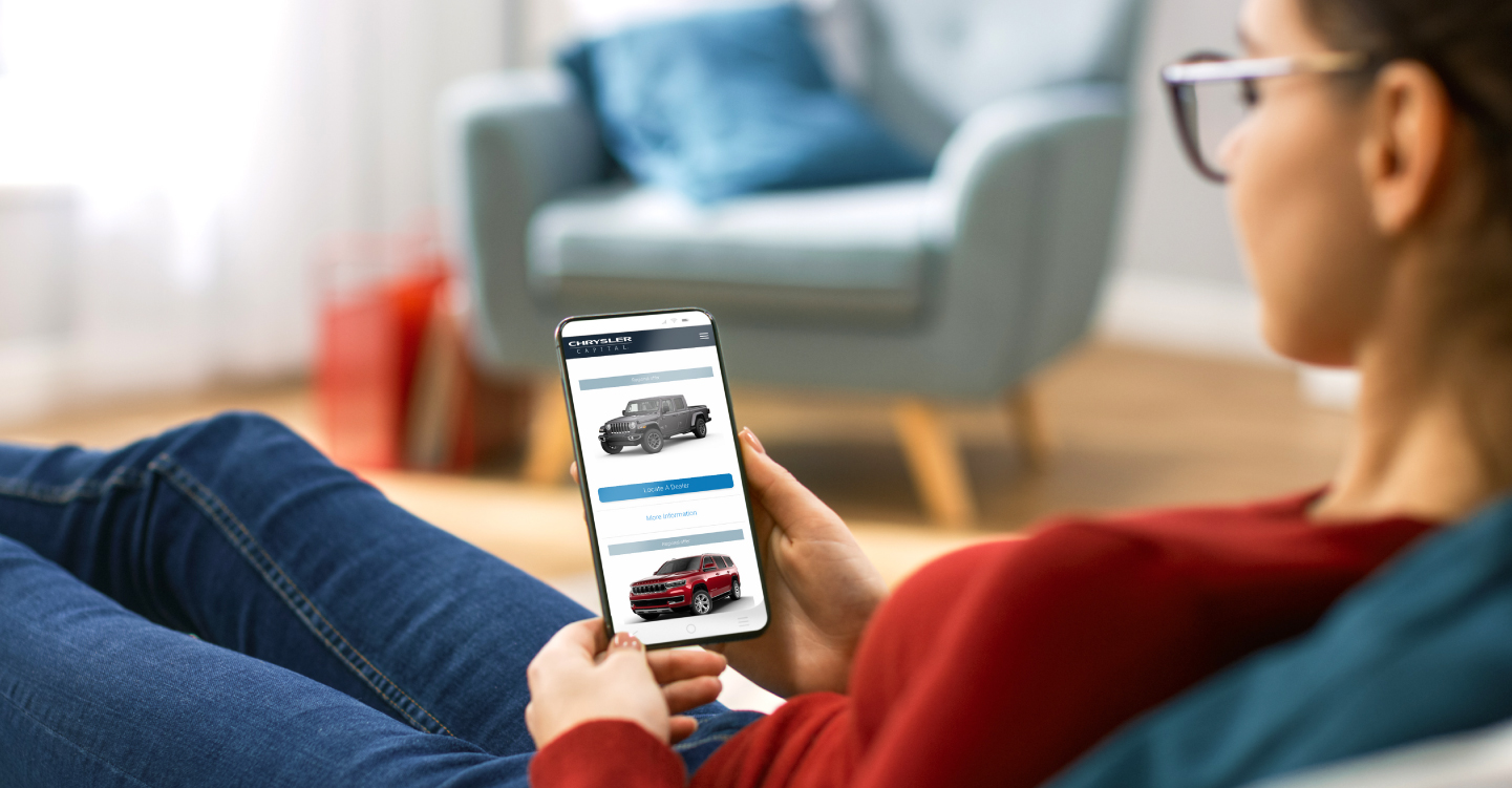 Woman looking for best vehicle incentives on phone