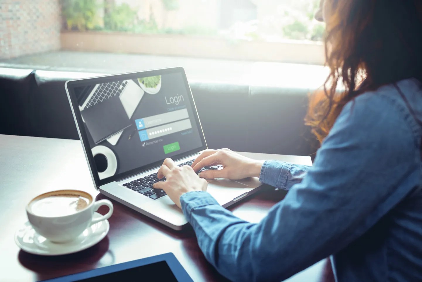 Woman logging into account on computer